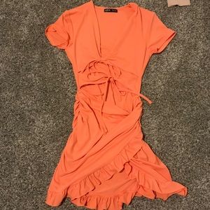 Pinkish orange dress, stops above knees